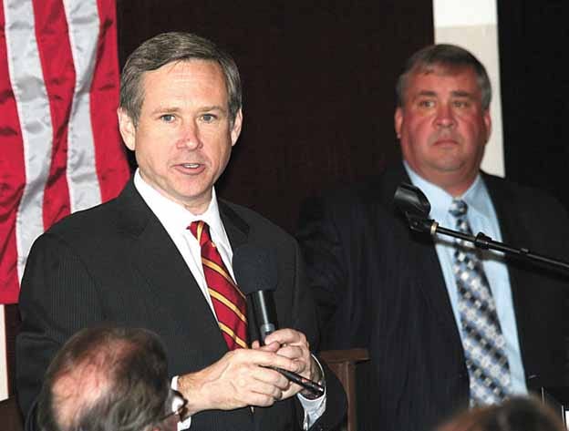 Sen. Mark Kirk, left, speaks at the Lincoln?Day Luncheon in Toulon?Saturday. At right is Mike Bigger, Stark County Republican chairman.