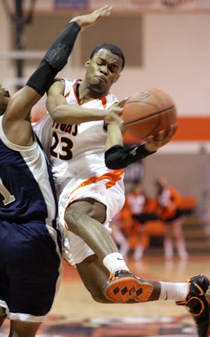Massillon’s Antoine McElroy drives to the basket against Lorain defender Tevvin Jones during Tuesday’s game at Massillon. A strong third quarter lifted the Tigers to a 68-55 win over Lorain.