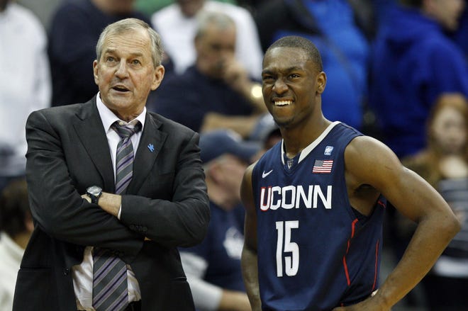 Connecticut head coach Jim Calhoun, left, stands with player Kemba Walker (15) near the end of the second half of an NCAA college basketball game against Seton Hall, Saturday, Feb. 5, 2011 in Newark, N.J. Connecticut won 61-59.