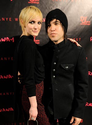 In this Oct. 18, 2010 file photo, Pete Wentz and his wife Ashlee Simpson-Wentz arrive for a screening of "Runaway," in Los Angeles. (AP Photo/Chris Pizzello, file)