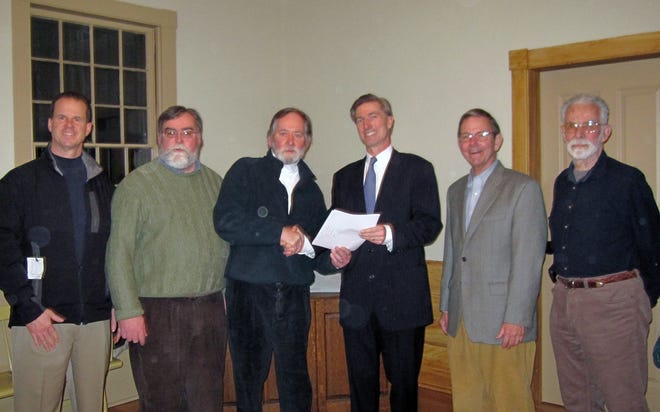 The Sudbury Board of Selectmen, from left, Bob Haarde, Larry O'Brien, and Chairman John Drobinski, present Article 2 to state Rep. Tom Conroy, D-Wayland, during the board's meeting on Feb. 3. Standing with the group are the authors of the article Ralph Tyler and Dave Levington.
