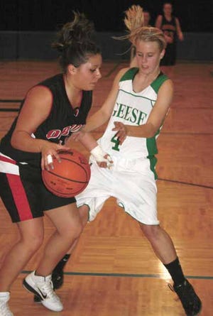 Wethersfield’s Kayla Bennett (4) pressures Orion’s Abby Taets during Galva Regional action Wednesday night.
