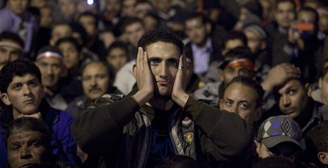 Anti-government protesters watch on big screen as Egyptian President Hosni Mubarak makes a televised statement to his nation in Tahrir Square in downtown Cairo, Egypt, Thursday.