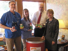 Dentists Robert Huffman, left, Meredith Clark and Dale Deines with Arden Dental Group on Hendersonville Road stand with Donna Pierce with Special Gifts Services with MANNA FoodBank in Asheville.