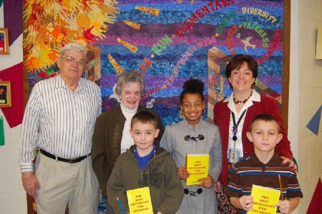 Students, from left, Devin Donadio, Angelina Parks and Joseph Wallis proudly display their dictionaries presented by Harold Litts and Carol I Hutson. Accepting the dictionaries for the third grade class is Principal Regina K. Schank.