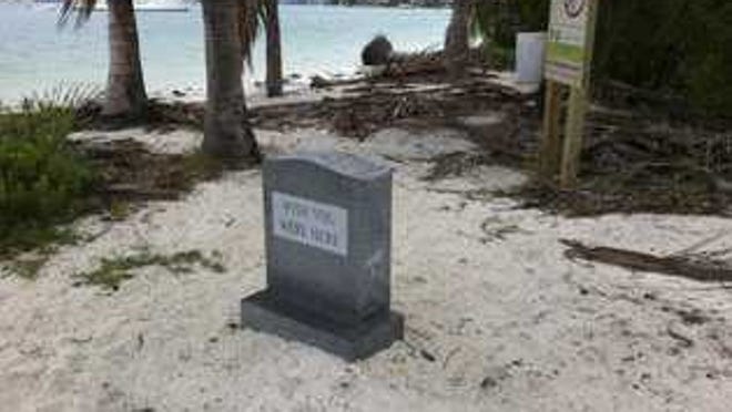 This tombstone, left on Monument Island for weeks after a December art bash, is one of the pieces of evidence of the parties that are often held on the deserted Miami Beach island.