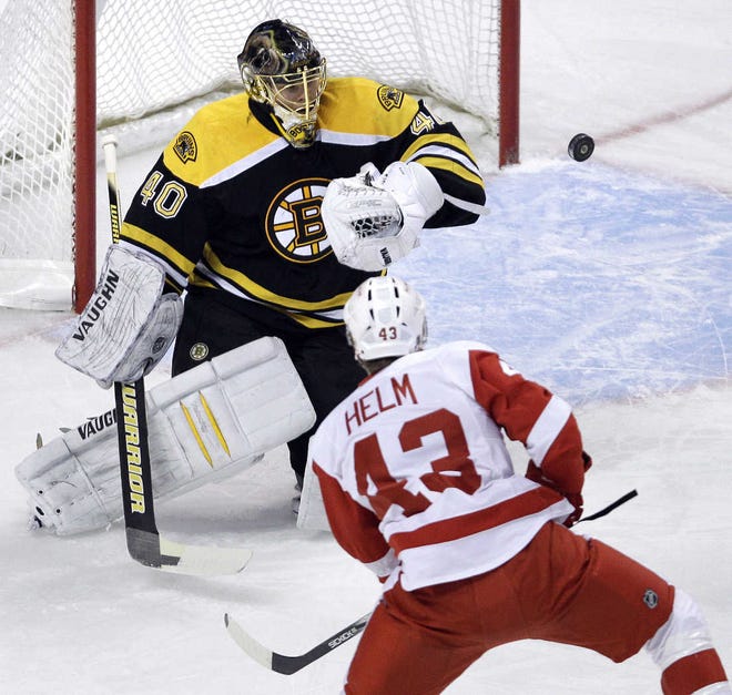 Bruins goalie Tuukka Rask makes a save on a shot by Red Wings center Darren Helm.