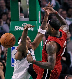 Celtics forward Paul Pierce, left, fouls Heat forward LeBron James.