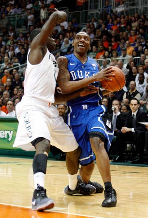 Duke's Nolan Smith, right, drives around Miami's Durand Scott in the first half of an NCAA college basketball game in Coral Gables, Fla., Sunday, Feb 13, 2011. (AP Photo/Alan Diaz)