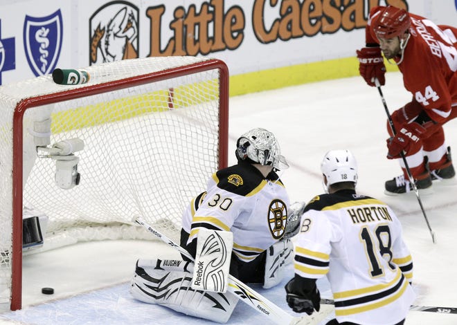 Red Wings forward Todd Bertuzzi (right) scores one his two goals on Bruins goalie Tim Thomas (30) during Detroit's 4-2 win over Boston yesterday.
