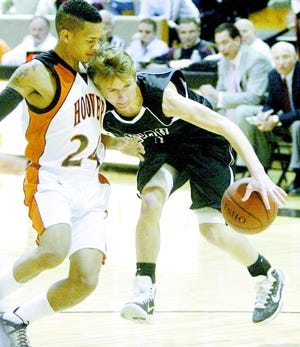 Hoover's Nyles Evans defends against Perry's Nick Williams during a recent Federal League game.