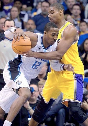 Orlando Magic center Dwight Howard is fouled by Los Angeles Lakers center Andrew Bynum during Sunday's game in Orlando. By PHELAN M. EBENHACK, AP