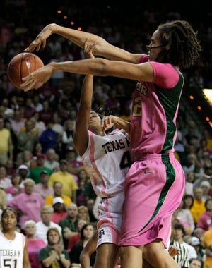Baylor center Brittney Griner blocks a shot attempt by Texas A&M guard Sydney Carter. Baylor won its 21st game in a row.