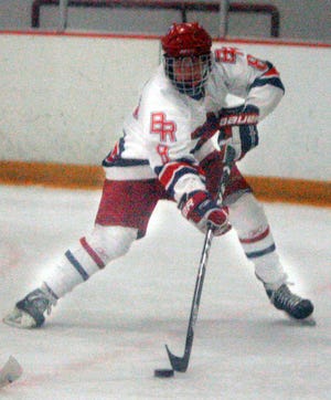 Bridgwater-Raynham's Matt White looks to pass the puck in front of the net vs. Falmouth Monday night.