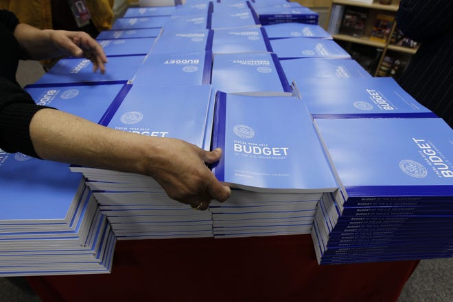 Copies of the U.S. Government budget for Fiscal Year 2012 are stacked up at the U.S. Government Printing Office in Washington, Monday, Feb. 14, 2011.