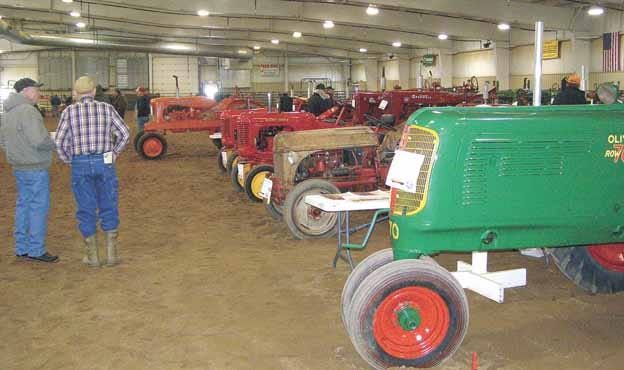 An Oliver 70 Row Crop owned and restored by Gene VandeVoorde of Annawan, right, begins a line of vintage tractors on display at a Celebration of the History of Agriculture held Saturday at Black Hawk College East Campus.