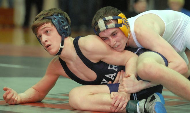 Bacon's Matt McAllister, right, wrestles Ledyard's Matthew Jones, left, in the 112-pound match, the final match of the ECC wrestling championships at Fitch High School in Groton Saturday, February 12, 2011. McAllister and Bacon won the championship title.