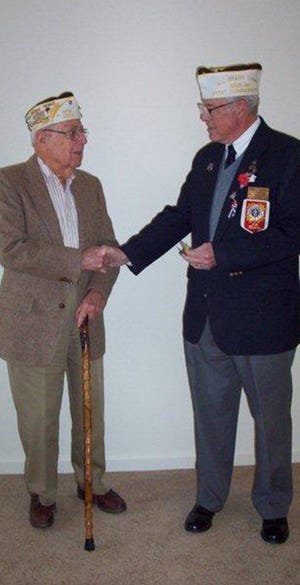 Max Izer, left, received a pin denoting 65 years as a member of Greencastle VFW Post 6319. The presentation was made by Chaplain Tom Cavanaugh.