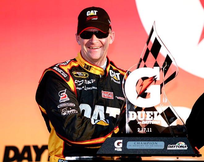Jeff Burton poses with the trophy after winning the second of two qualifying auto races for Sunday's NASCAR Daytona 500, at Daytona International Speedway in Daytona Beach, Fla., Thursday, Feb. 17, 2011. (AP Photo/Terry Renna)