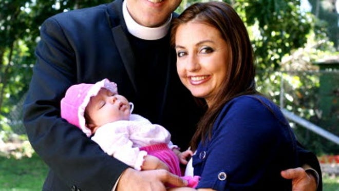 Father Alberto Cutié, left, with wife Ruhama Cutié, right, and two-month old daughter Camila Victoria Cutié, at the Episcopal Church of the Resurrection in Biscayne Park Sunday, Jan. 30, 2011.