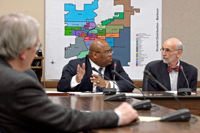 Rockford School Board member Bob Evans (from left) listens as former Rockford mayors Charles Box and John McNamara speak Wednesday, Feb. 16, 2011, during a meeting at the Administration Building in Rockford.