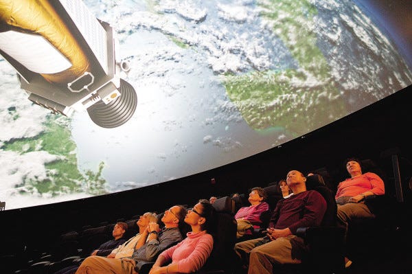 Michael Malyszko photos/The Museum of Science
An audience at the newly transformed Charles Hayden Planetarium enjoys a scene from "Undiscovered Worlds: The Search Beyond Our Sun." This is an artistic rendering of NASA’s Kepler spacecraft in its search for Earth-sized exoplanets.