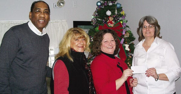 FOR THE HOMELESS: Stacey Ann LeRoy Foundation vice president and co-founder Mary Donovan and board member Marybeth Richardson presented a donation to Tom Washington, community relations manager for Father Billís and MainSpring, and Janice McCormick, site manager for Conway House.