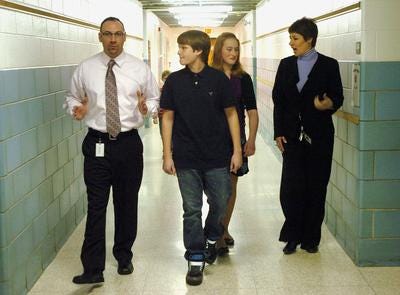 Jonathan Harte (left), superintendent of special services and curriculum at the Hainesport School, walks with eighth-graders Dylan James and Haley Bunting,
and Virginia Grossman, superintendent/principal, on Thursday during an event in which James and Bunting shadowed the administrators.