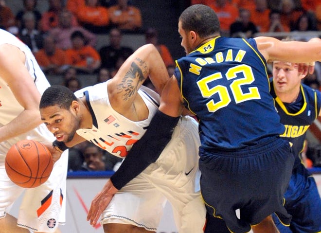Illinois guard Demetri McCamey (32) drives past Michigan forward Jordan Morgan (52) during an NCAA college basketball at Assembly Hall in Champaign, Ill., on Wednesday, Feb. 16, 2011. (AP Photo/Robin Scholz)