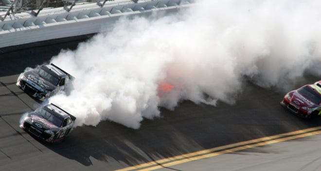 Smoke billows from Kevin Harvick's car (bottom, left) after an engine problem. It was rare mechanical issue for Richard Childress Racing.
