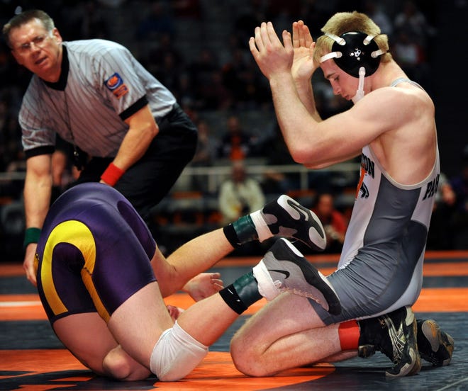 Dylan Reel of Washington applauds his own pin of Pete Koostra of Wauconda in the third-place 160lb. of the Class 2A IHSA State Wrestling Tournament.