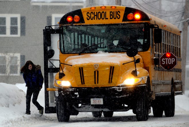 A student gets off the bus after an early dismissal during a recent snowstorm in Massachusetts.