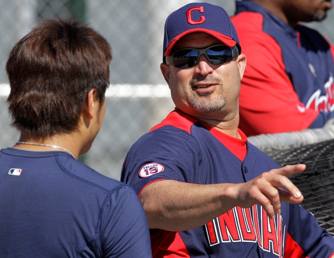 Cleveland Indians manager Manny Acta, right, talks with outfielder Shin-Soo Choo during spring training practice Thursday in Goodyear, Ariz.
