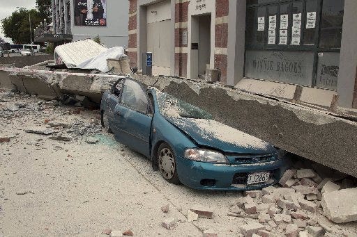 A car is crushed by a beam in central Christchurch, New Zealand, Tuesday, Feb. 22, 2011. A powerful earthquake collapsed buildings at the height of a busy workday killing and trapping dozens in one of the country's worst natural disasters.