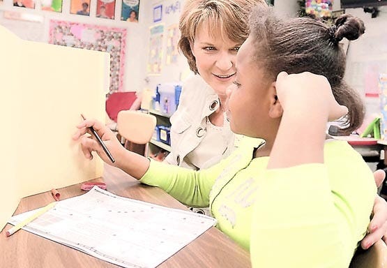Ketterlinus Elementary School fourth grade teacher Beth Upchurch works with Jaedan Mack on a math problem on Tuesday. Upchurch is this year's teacher of the year for St. Johns County. By PETER WILLOTT, peter.willott@staugustine.com