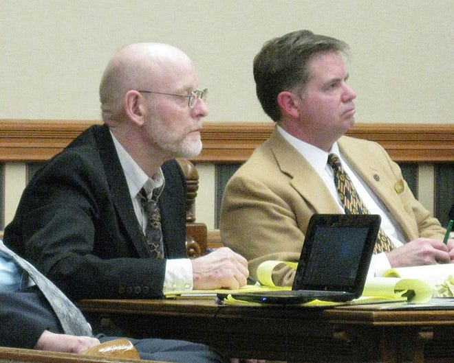Roger Hollister, 59, listens to testimony Tuesday afternoon during his capital murder trial in Atchison while seated next to Joseph Huerter, a defense attorney from Topeka.