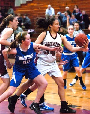 Brockton's Alicia Rosario, right, gets an offensive rebound in frnt of Braintree defender Taylor Russell in the fourth quarter of their game on Tuesday Feb.22, 2011, in Brockton. Brockton High School defeated Braintree High School in girls basketball 52-46.