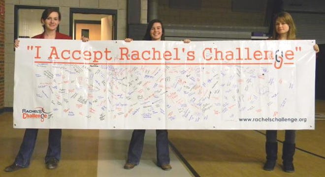 Blackstone Valley Regional Vocational Technical High School juniors, from left, Beth Belanger, Mollie Letendre and Melissa Burdick display the banner students signed accepting Rachel's Challenge to make positive changes at the school.