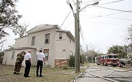 St. Augustine Fire Chief Michael Arnold, right, talks with Assistant Chief John Rayno, middle, after gaining control over a house fire on Weeden Street on Wednesday. By DARON DEAN, daron.dean@staugustine.com