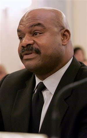 FILE - In this Set. 18, 2007 file photo, former Chicago Bears safety Dave Duerson testifies on Capitol Hill in Washington. The NFL wants all 50 states and the District of Columbia to pass legislation that could help cut down on concussions by youth football players. A quicker route would be through federal legislation, and the NFL backs a bill pending in Congress. But the GOP-led House is unlikely to support that kind of federal role in local matters, so the league sees a bigger opening at the state level. (AP Photo/Susan Walsh, file)