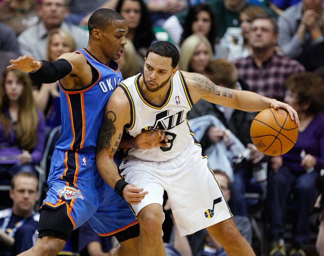 Utah Jazz guard Deron Williams drives along the baseline against Oklahoma City Thunder guard Russell Westbrook during the first half of a Feb. 5 game in Salt Lake City. Williams was traded to the New Jersey Nets on Wednesday.