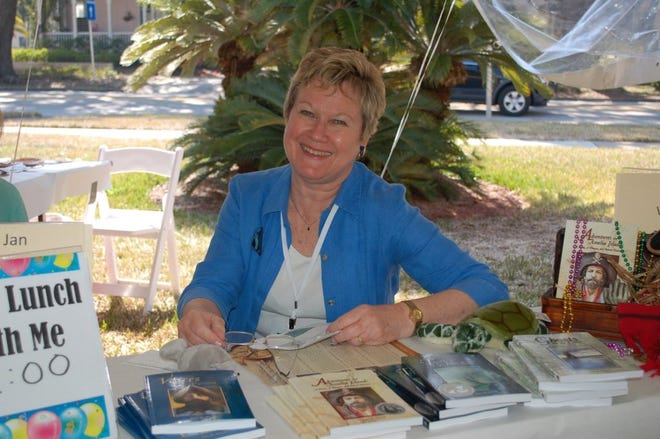 Jacksonville author Jane Wood signs her books under the children's tent at St. Peter's Episcopal Church in Fernandina Beach. Wood was a featured author at the Amelia Island Book Festival.