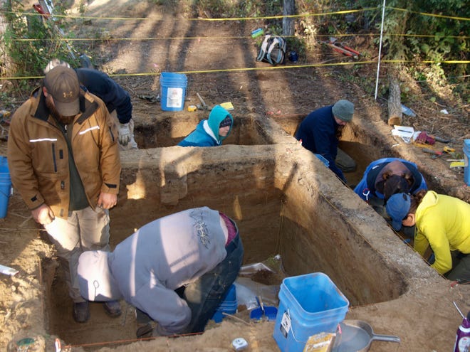 This handout photo, taken in Aug. 2010, provided by the journal Science shows excavating at the site in Alaska. Some 11,500 years ago one of America's earliest families laid the remains of a three-year-old child to rest in their home in what is now Alaska. Today archaeologists are learning about the life and times of the early settlers who crossed from Asia to the New World, researchers thank to that burial. (AP Photo/Ben A. Potter, Science)