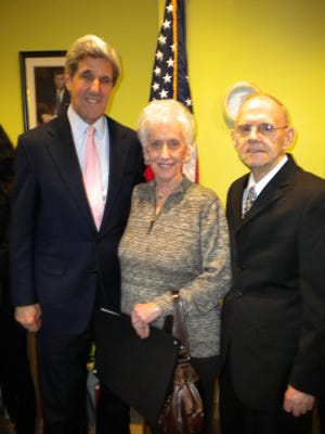 Sen. John Kerry stands with Don Abbott, right, and Ruth Slutzky, wife of Don Slutzky, a man who worked on the tower until a few weeks before it collapsed and who has been working closely with Sen. Kerry’s office receive this recognition.