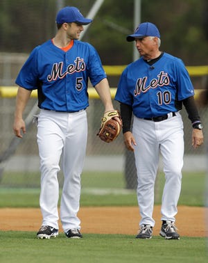 New York Mets' David Wright (left) talks with manager Terry Collins during spring training. The team said Friday that it had received a loan from Major League Baseball to cover expenses.