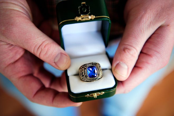 A ring is held by Sander Gossard Saturday, Feb. 26, 2011 at the Gossard household in Aiken, S.C. Recently a WWII ring was found in a Minneapolis, Minn. yard that was featured in the local newspaper. Word got around and people started contacting each other because it fit the description of Stanley Gossard's father's (William) lost ring from a few years ago. The 10 karat gold Jostens ring was professionally cleaned and was presented to Sander Gossard, Mark's nephew, this afternoon. Sander thought he was just coming over for dinner with his wife but turns out it was to pass on a family heirloom. The 27 year-old Navy Ensign plans to keep the ring in the box and preserved, waiting to pass it along in the family at the right time in the distant future. "I was surprised and flattered," Sander said. "I used to play with it as a kid, but grandpa never talked much about World War II."