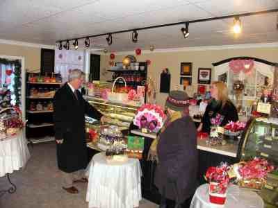 Submitted Photo - Pictured at Sweetbriar’s candy shop in Warwick, N.Y., are Michael A. Johndrow, executive director of the Warwick Valley Chamber of Commerce; Ronnie Havens, right, new owner of Sweetbriar’s; and customer Pip Klein.