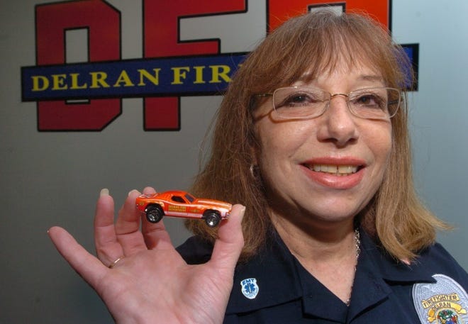 Delran Fire Department employee Angela Bauer holds the newly released Hot Wheels car showcasing the fire department.