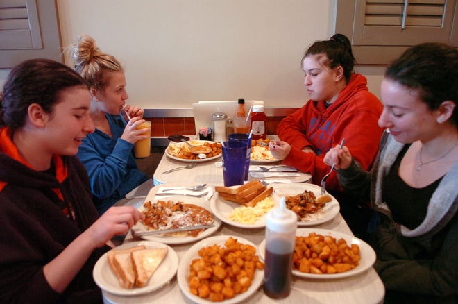 Ava Siegel, 12, of Stoughton, from left, Sarah Schwartz, 21, of Easton, her sister, Lindsay, 25, and Marlena Siegel, 16, enjoy a meal Sunday at the newly renovated Stonebridge Cafe.