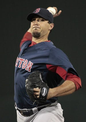 Red Sox pitcher Josh Beckett delivers a pitch during the first inning of last night's loss to the Twins. Beckett allowed one run in two innings in his spring debut.